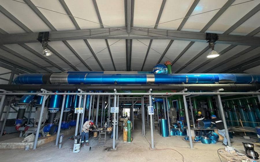 Chilled water plant room under installation with primary distribution pipework