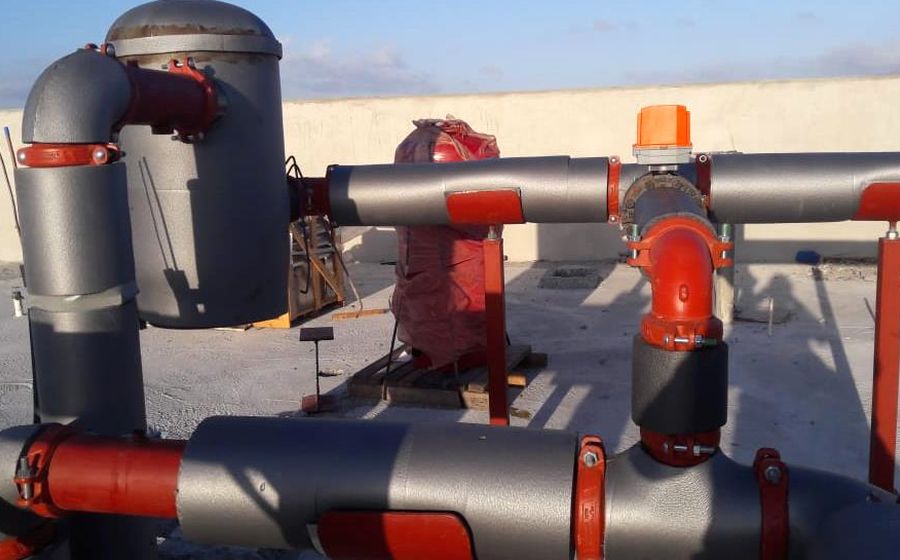Plant room pipework with pumps, strainers and headers in insulated steel