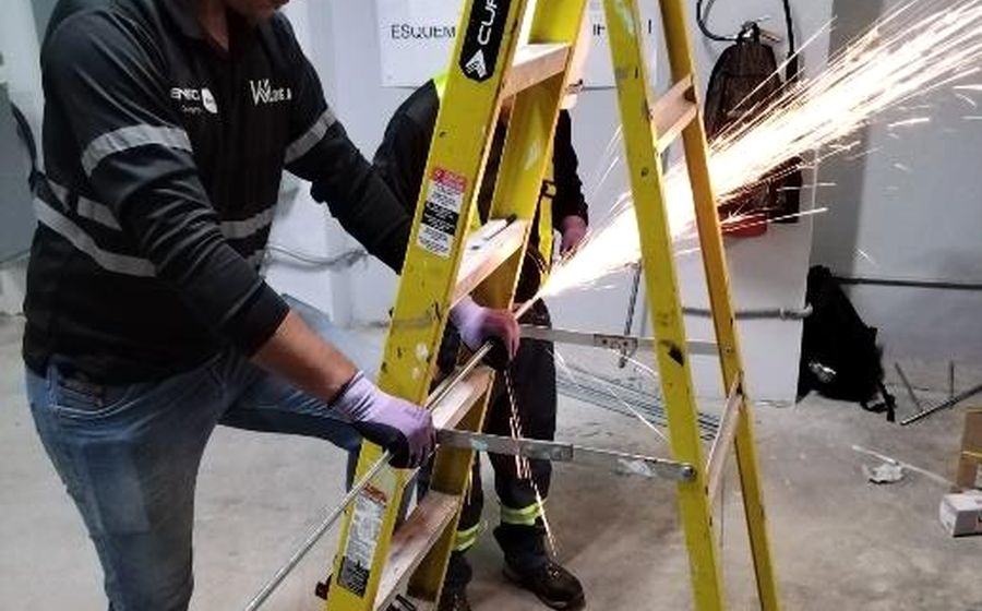 Installation crew cutting steel on site during a fit-out