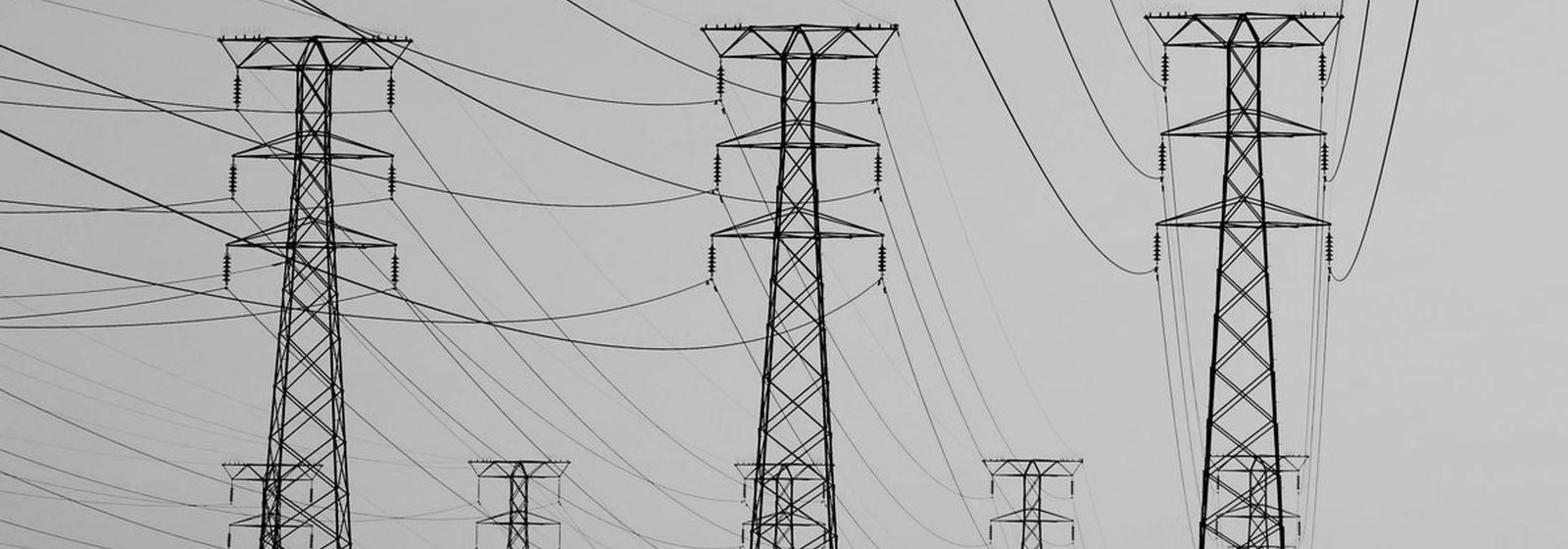 High-voltage transmission towers carrying power across open country